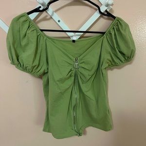 Green shoulder top, puffed sleeves. Zipper down the middle that does work.